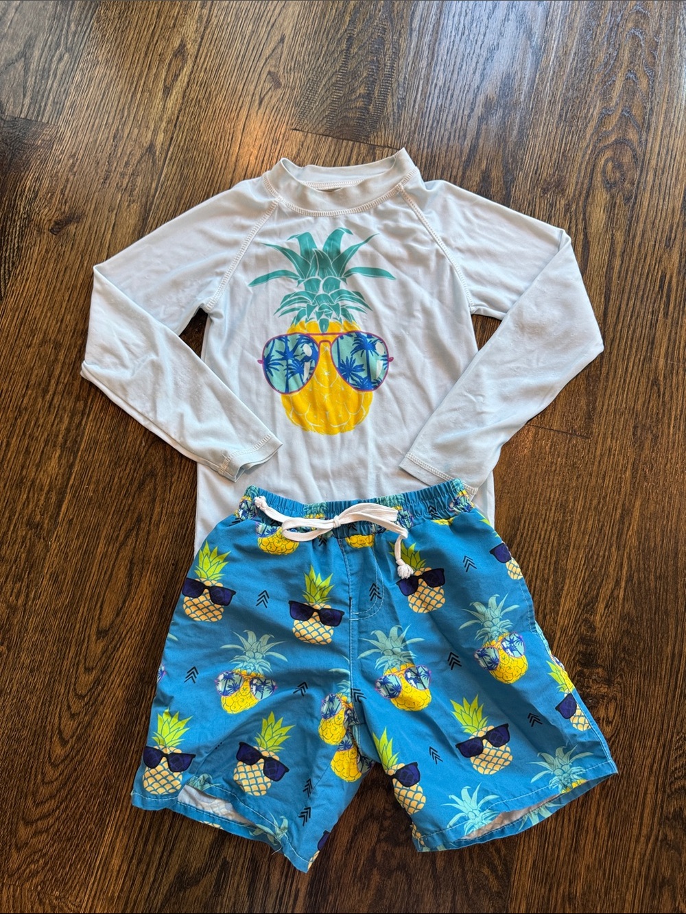 Pineapple swim trunks and rashguard